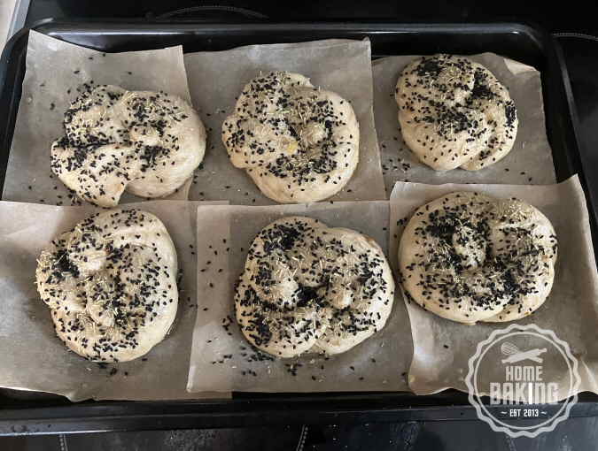 Pretzel Rolls egged washed and sprinkled with Onion Seeds and Rosemary